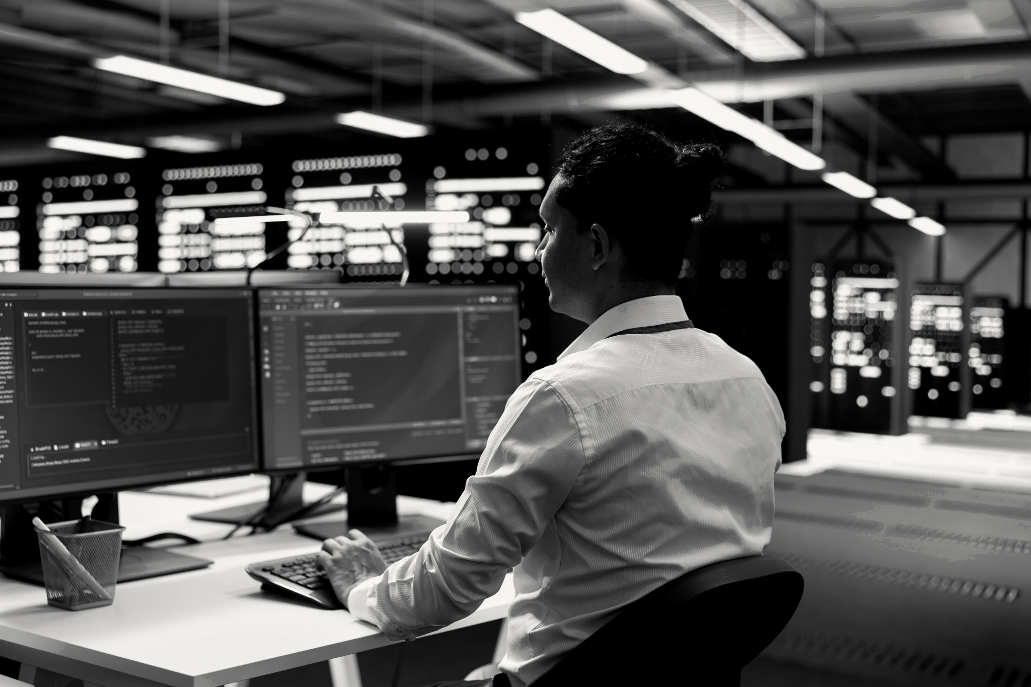 Operator working at multiple screens in a technical operations environment